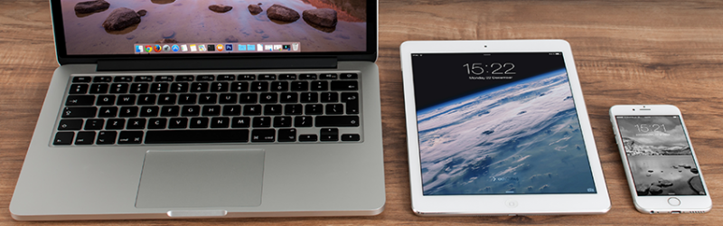 Laptop, tablet, and iPhone on desk