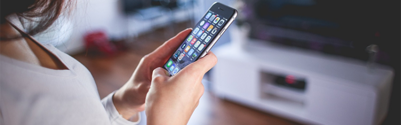 Woman using mobile apps on iPhone