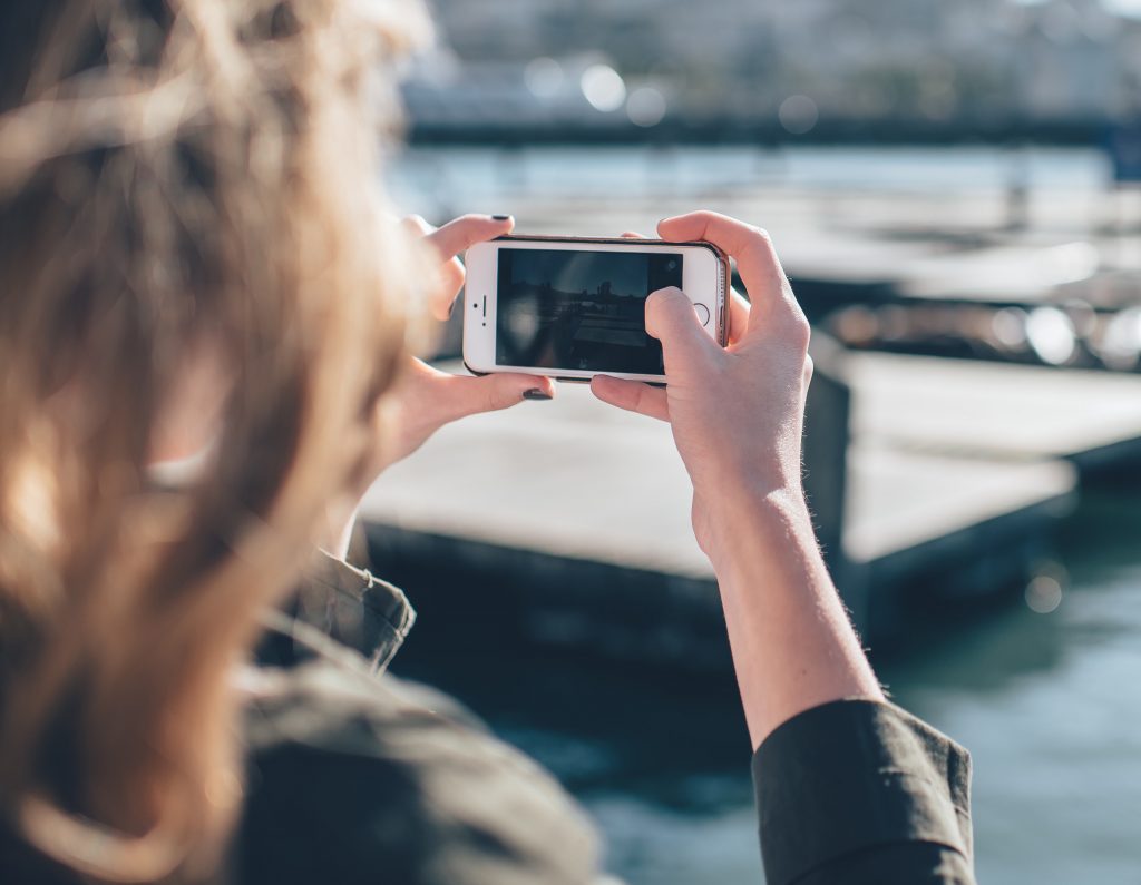 Woman taking photo on smartphone